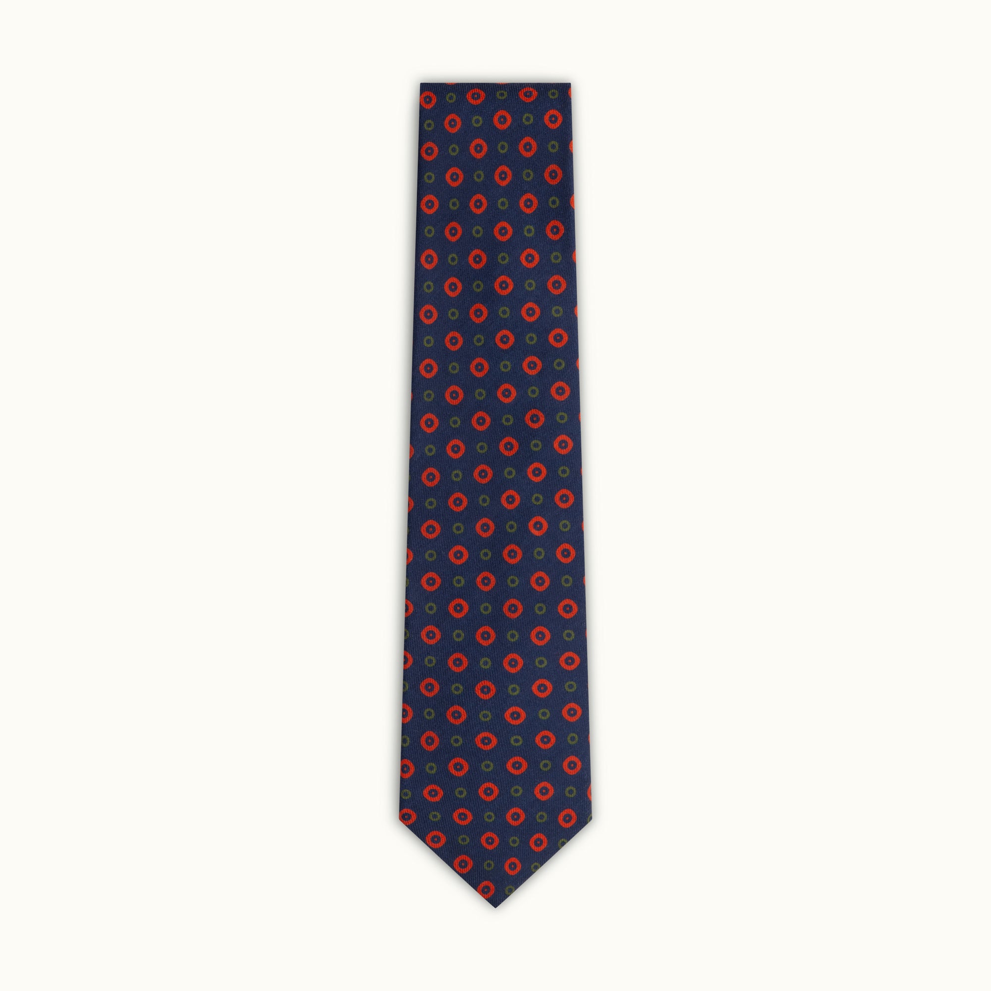 A navy wool challis tie with a red circle pattern.